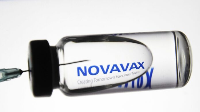 In this photo illustration a medical syringe and a vial